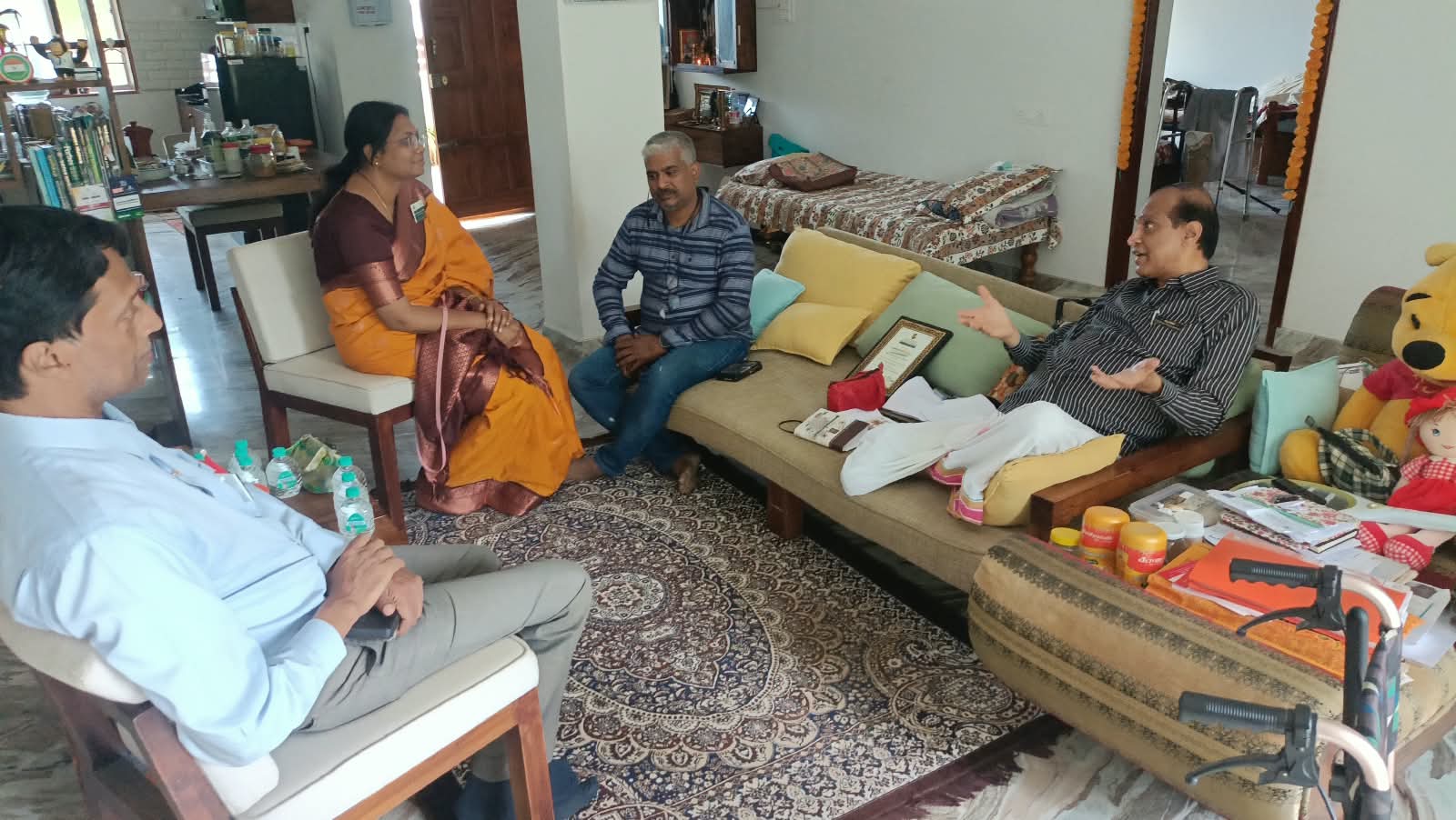 Mukudan Sir speaking with the soap-making class team